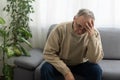 Elderly man with hand on his temple has a headache Royalty Free Stock Photo