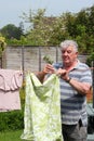 Elderly man hanging out the washing. Royalty Free Stock Photo