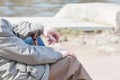 The elderly man has a rest on the embankment Royalty Free Stock Photo