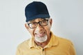 Elderly man, hat and glasses with modern style, casual and trendy fashion in studio with smile. Happy indian man Royalty Free Stock Photo