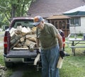 Elderly Man Helping Stack Firewood Royalty Free Stock Photo