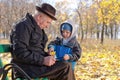 Elderly man with his grandson in the park Royalty Free Stock Photo