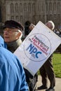 Elderly man holding a placard