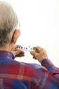 Elderly man holding seven-day pill box. Royalty Free Stock Photo