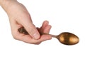 An elderly man holds in his hand a vintage spoon with a dull oxidized gold coating. Isolated