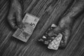 Elderly man holds in his hands the drugs and money.