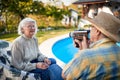 Elderly man at holiday and captures with a camera his woman Royalty Free Stock Photo