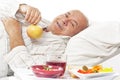 Elderly man in hospital bed eating Royalty Free Stock Photo