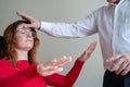 An elderly man hypnotizes a female patient. A woman in a session with a male hypnotherapist during a session. Therapist