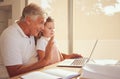 Elderly man, laptop and child on video call speaking and waving while relaxing in the family home. Happy, smile and Royalty Free Stock Photo