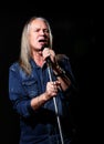 elderly man with long gray hair sings into a microphone Royalty Free Stock Photo