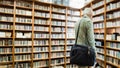 Elderly man looking at books in the Library