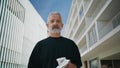 Elderly man looking camera on street closeup. Smiling bearded senior drinking Royalty Free Stock Photo