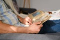 An elderly man looks through an album with old photographs, a concept of memories of youth, childhood, remembering his life, Royalty Free Stock Photo