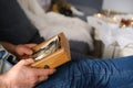 An elderly man looks through his old photographs of 1960-1965, the concept of nostalgia and memories of youth, childhood, Royalty Free Stock Photo