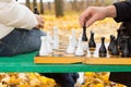 Elderly man making a chess move