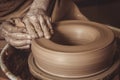 Elderly man making pot using pottery wheel in studio Royalty Free Stock Photo