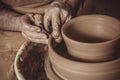 Elderly man making pot using pottery wheel in studio Royalty Free Stock Photo