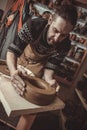 Elderly man making pot using pottery wheel in studio Royalty Free Stock Photo