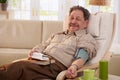 Elderly man measuring blood pressure