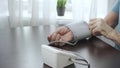 An elderly man is measuring his blood pressure Royalty Free Stock Photo