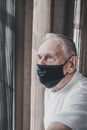 Elderly man in a medical mask in quarantine. Protecting the people around you from the virus. the concept of a pandemic. Masked