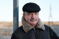 An elderly man with a mustache is wearing a cap Royalty Free Stock Photo