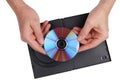 An elderly man with nostalgia looks at an old DVD on which family events are recorded. Isolated Royalty Free Stock Photo