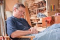 Elderly man peacefully resting in workshop chair