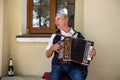 An elderly man playing the russian accordion