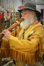 Elderly Man Playing a Wooden Flute Pipe
