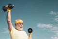 Elderly man practicing sports on blue sky background. Healthy lifestyle concept. Senior sportsman in sport center Royalty Free Stock Photo