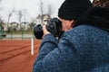 elderly man professional reporter sports photographer photographs a competition on tennis court. Photographer with a Royalty Free Stock Photo