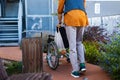 Elderly man pushing his own wheelchair. Wheelchair for support and balance for senior with walking difficulty. Royalty Free Stock Photo