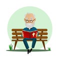 Elderly man reads the Bible while sitting on a park bench. Royalty Free Stock Photo