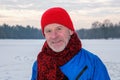 Elderly man standing in winter forest, resting after exercise Royalty Free Stock Photo