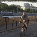 An elderly man is riding along the Moskva river embankment