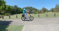 elderly man riding electric bicycle along path on sunny day