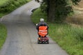 Elderly man riding mobile scooter, Netherlands