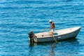 Elderly Man Rowing on his White Motorboat - Mediterranean Sea Italy Royalty Free Stock Photo