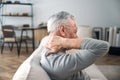 Elderly man rubbing hard pain in neck and massaging tense muscles Royalty Free Stock Photo