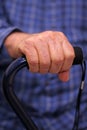 Elderly man's hand on cane