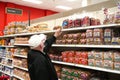 Elderly man\'s hand rests on upper shelf in Target store where bread loaves are missing