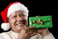 Elderly Man with Santa Cap And Green Wrapped Gift Royalty Free Stock Photo