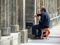 Old man playing violin to Berlin in Germany.