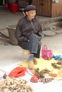 Portrait of elderly happy man selling ginger, Xingping, China