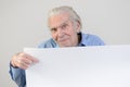 Elderly man showing a blank whiteboard Royalty Free Stock Photo