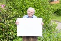 Elderly man showing a blank whiteboard Royalty Free Stock Photo