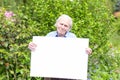 Elderly man showing a blank whiteboard Royalty Free Stock Photo