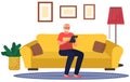 Elderly man sitting on couch with tablet pc, working at home with electronic equipment in his hands